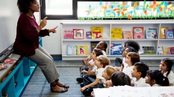 Small image of woman instructing classroom